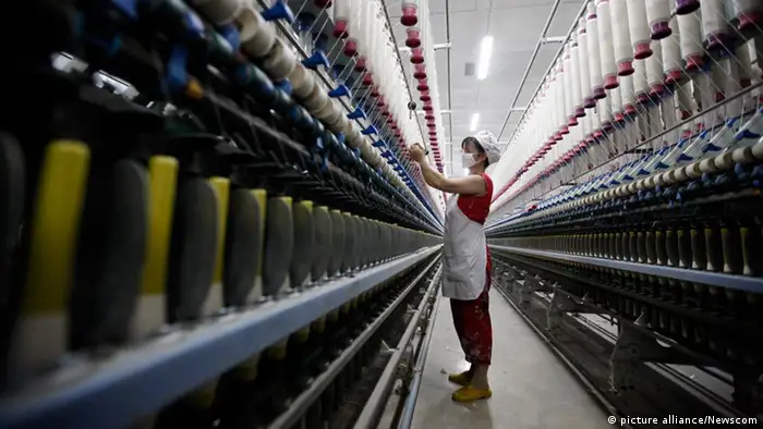 A woman works in a textile factory in Huaibei in central China's Anhui province Wednesday July 13, 2011. China says its Gross Domestic Product expanded by 9.5% in the second quarter, slowed from 9.7% in the first quarter. Photo via Newscom picture alliance