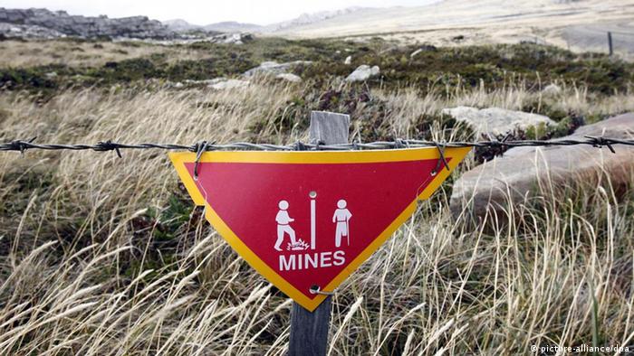 A sign with babed wire warning against landmines