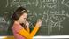 A girl in front of a blackboard A girl in front of a blackboard