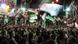 Syrians wave revolutionary flags and chant slogans at a night protest against Assad Syrians wave revolutionary flags and chant slogans at a night protest against Assad