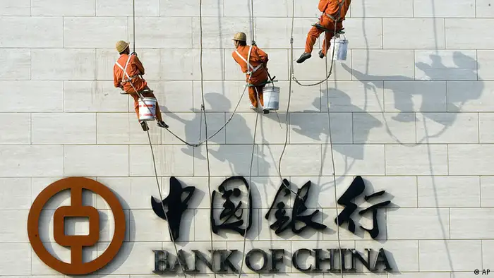 Chinese workers scale the wall near the logo for the Bank of China Ltd., China's second biggest commercial bank in Beijing, China, Monday, Oct. 2, 2006. China's banks have seen revenues soar amid double-digit growth in lending despite government efforts to cool off an economy that expanded by 11.3 percent in the second quarter. Bankers are racing to modernize operations as Beijing prepares to meet a Dec. 11 deadline for fully opening their market to foreign competitors under World Trade Organization commitments.(ddp images/AP Photo/Ng Han Guan)