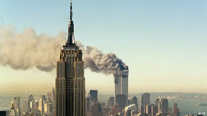 **FILE** The twin towers of the World Trade Center burn behind the Empire State Building in New York, in this Sept. 11, 2001 file photo. Born in the Great Depression, it has weathered economic hardship, world war, labor strikes, murder, terrorist fears and yes, even its own plane crash. On Monday, May 1, 2006, the Empire State Building turns 75 years old, a diamond jubilee for New York City's crown jewel. (ddp images/AP Photo/File, Marty Lederhandler).