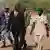Mali coup leader Captain Amadou Sanogo walks with members of his staff at the Kati military camp near Bamako