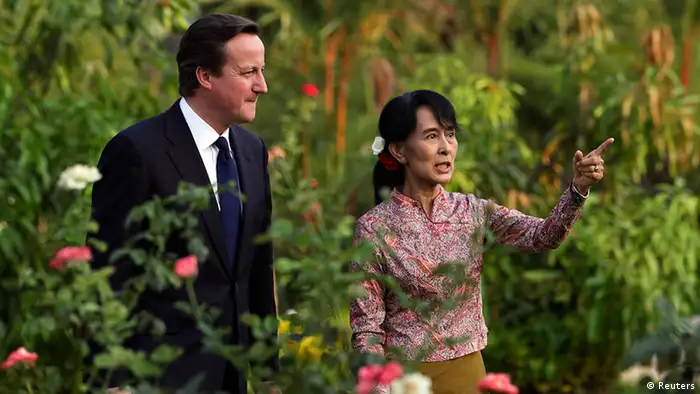 Britain's Prime Minister David Cameron (L) listens to Nobel laureate and newly elected parliamentarian Aung San Suu Kyi at her residence in Yangon April 13, 2012. REUTERS/Damir Sagolj (MYANMAR - Tags: POLITICS TPX IMAGES OF THE DAY)