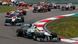 F1 cars come around a curve in a race F1 cars come around a curve in a race