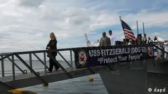 U.S. Secretary of State Hillary Rodham Clinton disembarks from the guided-missile destroyer USS Fitzgerald following a ceremony marking the 60th anniversary of the Mutual Defense Treaty between the U.S. and the Philippines Wednesday Nov. 16, 2011 at Manila's South Harbor. Clinton underlined America's military and diplomatic support for the Philippines as the island nation engages in an increasingly tense dispute with China over claims in the resource-rich South China Sea. (AP Photo/Bullit Marquez)