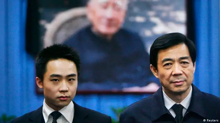 China's former Chongqing Municipality Communist Party Secretary Bo Xilai (R) and his son Bo Guagua stand in front of a picture of his father Bo Yibo, former vice-chairman of the Central Advisory Commission of the Communist Party of China, at a mourning hall in Beijing in this January 18, 2007 file photo. Bo Guagua, a 24-year-old descendant of Chinese Communist royalty, seemed destined to one day become a rich and powerful businessman in an economy that in his lifetime would become the world's largest. His pedigree, elite schooling, easy confidence and connections left those who knew him in no doubt he would pursue a business career and amass a fortune. That was until a British expatriate, Neil Heywood, died in November 2011 in a hotel in a huge city in western China, a world away from the clipped lawns and hushed libraries of Harvard University where Bo was studying. The story now looks certain to ruin his family and upend his ambitions. REUTERS/Stringer (CHINA - Tags: POLITICS CRIME LAW TPX IMAGES OF THE DAY) CHINA OUT. NO COMMERCIAL OR EDITORIAL SALES IN CHINA