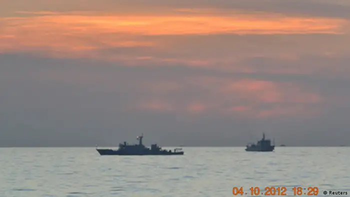 Two Chinese surveillance ships which sailed between a Philippines warship and eight Chinese fishing boats to prevent the arrest of Chinese fishermen in the Scarborough Shoal, a small group of rocky formations whose sovereignty is contested by the Philippines and China, about 124 nautical miles off the Philippine island of Luzon, are seen in the South China Sea in this April 10, 2012 file photo. China withdrew one of three ships engaged in a standoff with Philippines vessels in a disputed area of the South China Sea on April 13, 2012 as both sides pursued talks to defuse the dispute. REUTERS/Philippine Army Handout/Files (PHILIPPINES - Tags: POLITICS MILITARY MARITIME) FOR EDITORIAL USE ONLY. NOT FOR SALE FOR MARKETING OR ADVERTISING CAMPAIGNS. THIS IMAGE HAS BEEN SUPPLIED BY A THIRD PARTY. IT IS DISTRIBUTED, EXACTLY AS RECEIVED BY REUTERS, AS A SERVICE TO CLIENTS