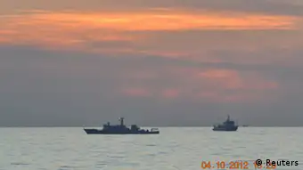 Two Chinese surveillance ships which sailed between a Philippines warship and eight Chinese fishing boats to prevent the arrest of Chinese fishermen in the Scarborough Shoal, a small group of rocky formations whose sovereignty is contested by the Philippines and China, about 124 nautical miles off the Philippine island of Luzon, are seen in the South China Sea in this April 10, 2012 file photo. China withdrew one of three ships engaged in a standoff with Philippines vessels in a disputed area of the South China Sea on April 13, 2012 as both sides pursued talks to defuse the dispute. REUTERS/Philippine Army Handout/Files (PHILIPPINES - Tags: POLITICS MILITARY MARITIME) FOR EDITORIAL USE ONLY. NOT FOR SALE FOR MARKETING OR ADVERTISING CAMPAIGNS. THIS IMAGE HAS BEEN SUPPLIED BY A THIRD PARTY. IT IS DISTRIBUTED, EXACTLY AS RECEIVED BY REUTERS, AS A SERVICE TO CLIENTS