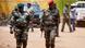 Guinea-Bissau officers cross a street as they leave a meeting in the country's capital Bissau Guinea-Bissau officers cross a street as they leave a meeting in the country's capital Bissau