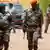 Guinea-Bissau officers cross a street as they leave a meeting in the country's capital Bissau