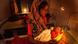 An Indian mother tends to her new born baby under a candle light during a power cut An Indian mother tends to her new born baby under a candle light during a power cut