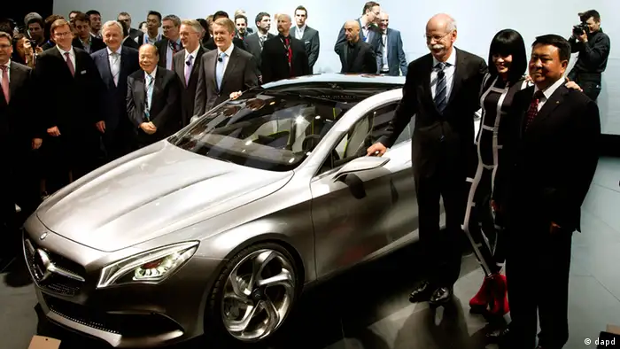 Daimler AG CEO Dieter Zetsche, third from right, stands with British singer Jessie J, second from right, and Daimler executives after he unveiled the Mercedes Benz Style Coupe at the Beijing International Automotive Exhibition in Beijing, China Monday, April 23, 2012. (AP Photo/Andy Wong)