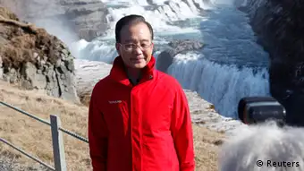 Chinese Premier Wen Jiabao poses before Gullfoss waterfall April 21, 2012. Wen landed in Iceland on Friday to begin a tour of northern Europe that will focus on Chinese investment in a continent eager for funds from the fast-growing Asian power. REUTERS/Ingolfur Juliusson (ICELAND - Tags: POLITICS)