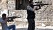In this Sunday April 22, 2012 photo, two Free Syrian Army fighters aim their guns, at Khalidiyeh neighborhood in Homs province, central Syria. In this Sunday April 22, 2012 photo, two Free Syrian Army fighters aim their guns, at Khalidiyeh neighborhood in Homs province, central Syria.