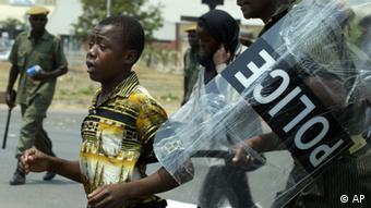 A police officer arrests a member of the opposition Patriotic Front party in Lusaka, Zambia, Sunday, Oct. 1, 2006.