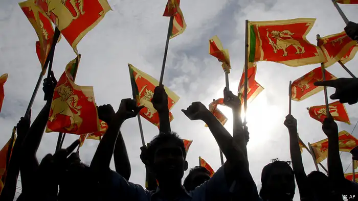 FILE - Sri Lankans wave their national flag during a victory rally to celebrate the defeat of the Tamil Tiger rebels, in Colombo, Sri Lanka, Friday, May 22, 2009. (AP Photo)