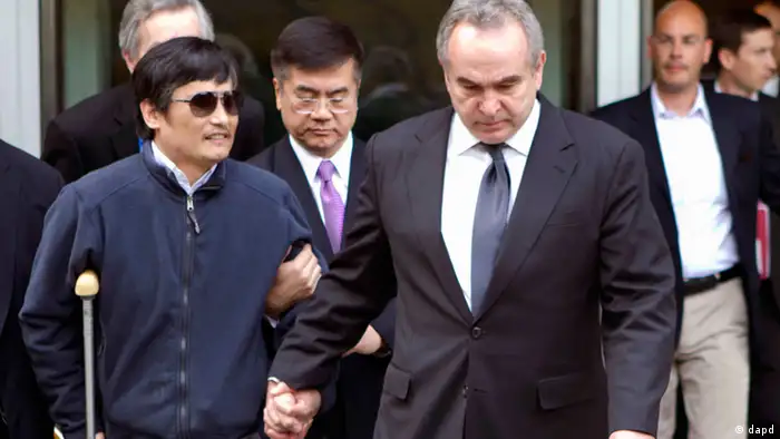 In this photo released by the US Embassy Beijing Press Office, blind lawyer Chen Guangcheng, left, is helped by U.S. Assistant Secretary of State for