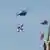 Russian helicopters carrying military insignias fly near the Kremlin