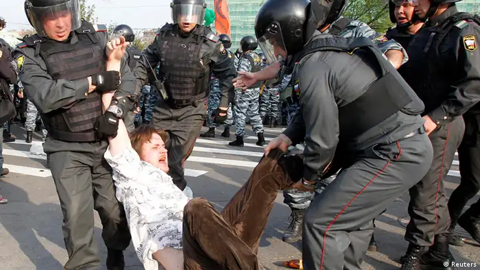 Russian riot police detain a participant during a march of the million opposition protest in central Moscow May 6, 2012. Thousands of people took to the streets of several Russian cities on Sunday to protest against Vladimir Putin on the eve of his return to the presidency, but opposition hopes of staging a march of a million fell flat. REUTERS/Denis Sinyakov (RUSSIA - Tags: POLITICS CIVIL UNREST)