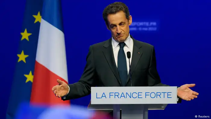 Nicolas Sarkozy, France's incumbent president, reacts after his defeat for re-election in the second round vote of the 2012 French presidential elections as he appears on stage before UMP party supporters at the Mutualite meeting hall in Paris May 6, 2012. REUTERS/Philippe Wojazer (FRANCE ELECTION - Tags: POLITICS ELECTIONS TPX IMAGES OF THE DAY) ELECTION)