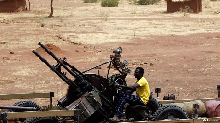 A SPLA-N fighter sits with an anti-aircraft weapon near Jebel Kwo village in the rebel-held territory of the Nuba Mountains in South Kordofan, May 2, 2012. REUTERS/Goran Tomasevic (SUDAN - Tags: CIVIL UNREST)