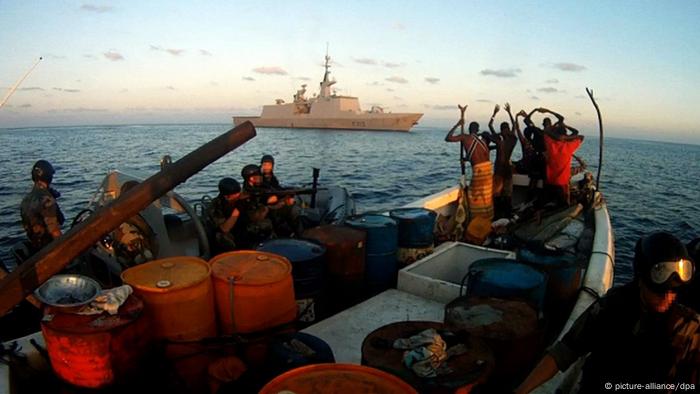 A group of suspected pirates is taken into custody by the crew of an EU warship