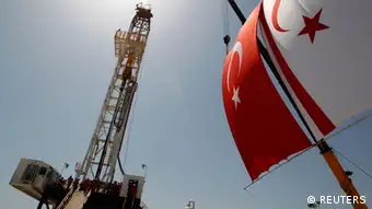 Turkish and Turkish Cypriot flags wave next to a drilling tower 25 km (16 miles) from Famagusta April 26, 2012. Turkish Cypriot Leader Dervis Eroglu and Turkey's Energy Minister Taner Yildiz attended a ceremony marking the start of joint gas and oil exploration works in northern Cyprus between Turkey's state-owned energy company TPAO and the Turkish-Cypriot administration. REUTERS/Umit Bektas (TURKEY - Tags: POLITICS ENERGY BUSINESS)