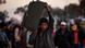 A man from Bangladesh, who used to work in Libya and fled the unrest in the country, carries his belongings as he arrives in a refugee camp after crossing from Libya at the Tunisia-Libyan border, in Ras Ajdir, Tunisia, Monday, March 21, 2011. (Foto:Emilio Morenatti/AP/dapd) A man from Bangladesh, who used to work in Libya and fled the unrest in the country, carries his belongings as he arrives in a refugee camp after crossing from Libya at the Tunisia-Libyan border, in Ras Ajdir, Tunisia, Monday, March 21, 2011. (Foto:Emilio Morenatti/AP/dapd)