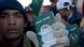Refugees from Bangladesh show their passports at the Libya-Tunisia border Refugees from Bangladesh show their passports at the Libya-Tunisia border