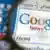 Unter einer Lupe ist auf einem Computerbildschirm in Schwerin das Logo der Internetsuchmaschinen-Firma Google zu sehen