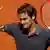 Roger Federer of Switzerland waves after winning his match against Tobias Kamke of Germany during the French Open tennis tournament at the Roland Garros stadium in Paris May 28, 2012. REUTERS/Benoit Tessier (FRANCE - Tags: SPORT TENNIS)