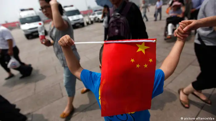 China 23rd anniversary of the Tiananmen Square massacre anniversa epa03248300 A Chinese boy holds up the national flag in Tiananmen Square on the 23rd anniversary of the Tiananmen Square massacre in Beijing, China, 04 June 2012. Hundreds, and possibly thousands, of students died in the Tiananmen Square area of Beijing in June 1989 when the Chinese government sent in troops to crush a pro-democracy uprising and preserve one-party rule in China. EPA/HOW HWEE YOUNG +++(c) dpa - Bildfunk+++