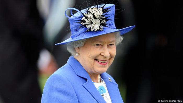  Queen Elizabeth II, smiling, in a blue outfit with a matching hat 