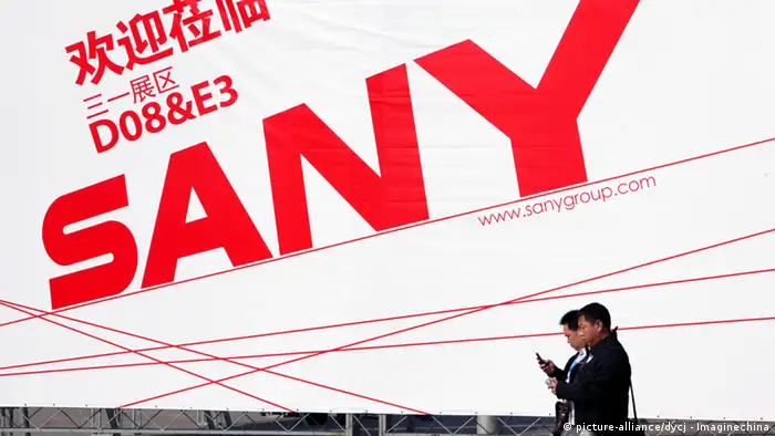 --File-- Visitors walk past an advertisement of Sany Heavy Industry Co., parent company of Sany Heavy Equipment International Holdings, during the 2010 International Trade Fair for Construction Machinery, Building Material Machines, Construction Vehicles and Equipment, known as BAUMA China 2010, at Shanghai New International Expo Centre (SNIEC) in Shanghai, China, November 24, 2010. The owners of Hong Kong-listed Sany Heavy Equipment International Holdings Co. Ltd. are planning to raise $300 million from the sale of shares in Brazil, via Brazilian depositary receipts to be listed on the Brazilian stock exchange, a senior company executive said Tuesday (February 22, 2011).