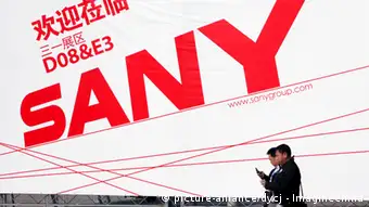 --File-- Visitors walk past an advertisement of Sany Heavy Industry Co., parent company of Sany Heavy Equipment International Holdings, during the 2010 International Trade Fair for Construction Machinery, Building Material Machines, Construction Vehicles and Equipment, known as BAUMA China 2010, at Shanghai New International Expo Centre (SNIEC) in Shanghai, China, November 24, 2010. The owners of Hong Kong-listed Sany Heavy Equipment International Holdings Co. Ltd. are planning to raise $300 million from the sale of shares in Brazil, via Brazilian depositary receipts to be listed on the Brazilian stock exchange, a senior company executive said Tuesday (February 22, 2011).