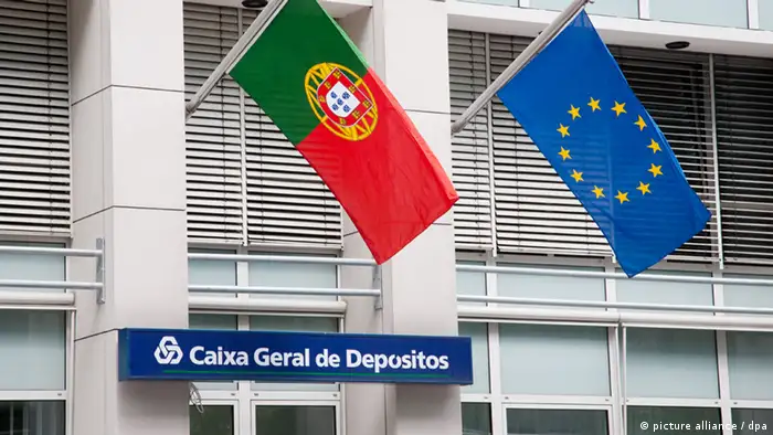 Die Flaggen von Portugal und der EU wehen am Montag (04.06.2012) in Berlin über einer Filiale der portugiesischen Bank Caixa Geral de Depositos. Nach Spanien muss jetzt auch Portugal die Banken mit staatlichen Mitteln stützen. Foto: Claudia Levetzow dpa/lbn +++(c) dpa - Bildfunk+++