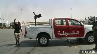 Source News Feed: EMEA Picture Service ,Germany Picture Service A vehicle mounted with an anti-aircraft gun is seen on the tarmac at Tripoli's international airport in this still image taken from video June 4, 2012. Clashes broke out between rival Libyan militias at Tripoli's international airport on Monday after angry gunmen drove armed pickup trucks on to the tarmac and surrounded planes, forcing the airport to cancel flights. REUTERS/Reuters TV (LIBYA - Tags: CIVIL UNREST POLITICS TRANSPORT)