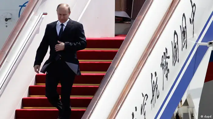 Russian President Vladimir Putin walks down from the airplane on his arrival at the Beijing Capital International Airport in Beijing, China Tuesday, June 5, 2012. Putin is in Beijing for a regional security summit and talks with Chinese leaders expected to focus on Syria, Iran, and energy cooperation. (AP Photo/Andy Wong)