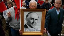 A supporter of the Bulgarian Socialist Party holds a portrait of Bulgaria's former Communist dictator Todor Zhivkov with a sign reading 22 years without him is getting worse with every day, during a rally to mark May Day, the International Labour day in Sofia, Sunday, May 1, 2011. (Foto:Valentina Petrova/AP/dapd)