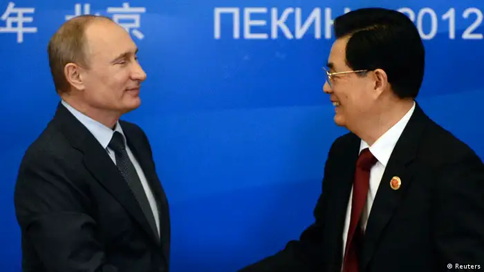 Russian President Vladimir Putin shakes hands with Chinese President Hu Jintao during a signing ceremony at the Shanghai Cooperation Organization (SCO) summit in the Great Hall of the People in Beijing June 7, 2012. REUTERS/Mark Ralston (CHINA - Tags: POLITICS)