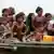 Rohingya refugees from Myanmar sit on a boat as they try to get into Bangladesh in Teknaf June 13, 2012.