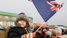 A child waves a Falklands flag in Stanley June 14, 2012, during commemorations for the 30th anniversary of the Falklands War. The tiny Falkland Islands will ask 3,000 inhabitants whether they want to stay part of Britain's self-governing overseas territories in a referendum designed to outflank Argentina's sovereignty claims to the South Atlantic archipelago. REUTERS/Enrique Marcarian (FALKLAND ISLANDS - Tags: POLITICS ANNIVERSARY)