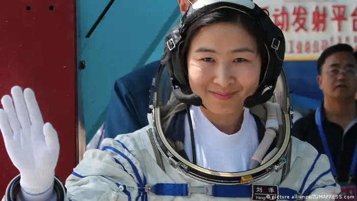 Chinese taikonaut Liu Yang, photographed in 2012, wears a spacesuit and smiles, waves