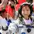 Liu Yang, China's first female astronaut, waves during a departure ceremony at Jiuquan Satellite Launch Center, Gansu province, June 16, 2012. China will send its first woman into outer space this week, prompting a surge of national pride as the rising power takes its latest step towards putting a space station in orbit within the decade. Liu, a 33-year-old fighter pilot, will join two other astronauts aboard the Shenzhou 9 spacecraft when it lifts off from a remote Gobi Desert launch site on Saturday evening. REUTERS/Jason Lee (CHINA - Tags: SCIENCE TECHNOLOGY TPX IMAGES OF THE DAY)