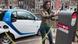 A woman charges an electric car in Amsterdam A woman charges an electric car in Amsterdam
