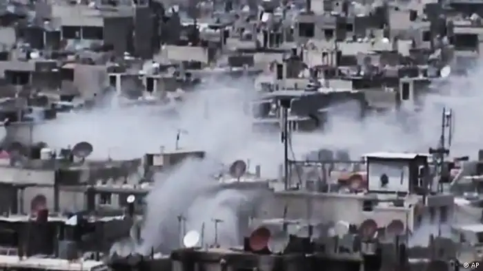 This image made from amateur video released by the Shaam News Network and accessed Saturday, June 16, 2012, purports to show smoke rising from buildings at Hamidiyeh neighborhood in Homs province, central Syria. The Syrian government, intent on wresting back control of rebel-held areas, launched a fierce offensive in recent days to recover territories in several locations, shelling heavily populated districts and using attack helicopters over towns and cities. (AP Photo/Shaam News Network via AP video) TV OUT, THE ASSOCIATED PRESS CANNOT INDEPENDENTLY VERIFY THE CONTENT, DATE, LOCATION OR AUTHENTICITY OF THIS MATERIAL