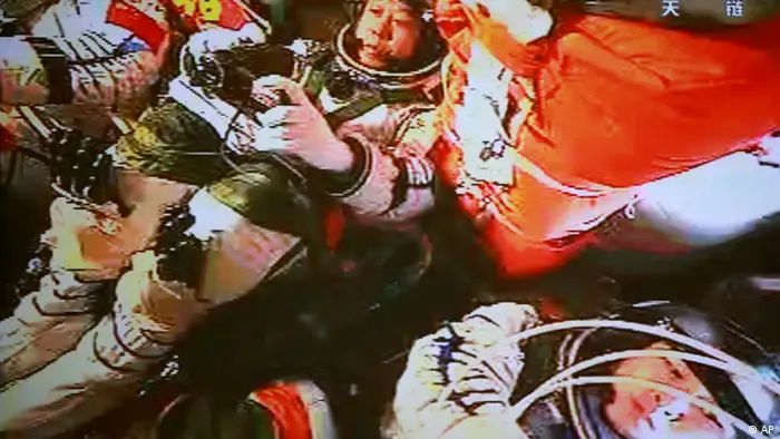 In this image made off the monitor screen at the Beijing Aerospace Flight Control Center and released by China's Xinhua News Agency, China's astronauts Jing Haipeng, center, Liu Wang, left with face not visible, and Liu Yang sit inside the Shenzhou-9 manned spacecraft while conducting docking with the Tiangong-1 space lab module Monday afternoon, June 18, 2012, 343 kilometers (213 miles) above Earth. (AP Photo/Beijing Aerospace Control Center via Xinhua) NO SALES