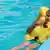 Ein Junge hält sich mit einer gelben Schwimmweste bekleidet am Beckenrand fest Foto: Alekseive (fotolia)