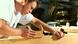 Young carpenter leaning over workbench Young carpenter leaning over workbench
